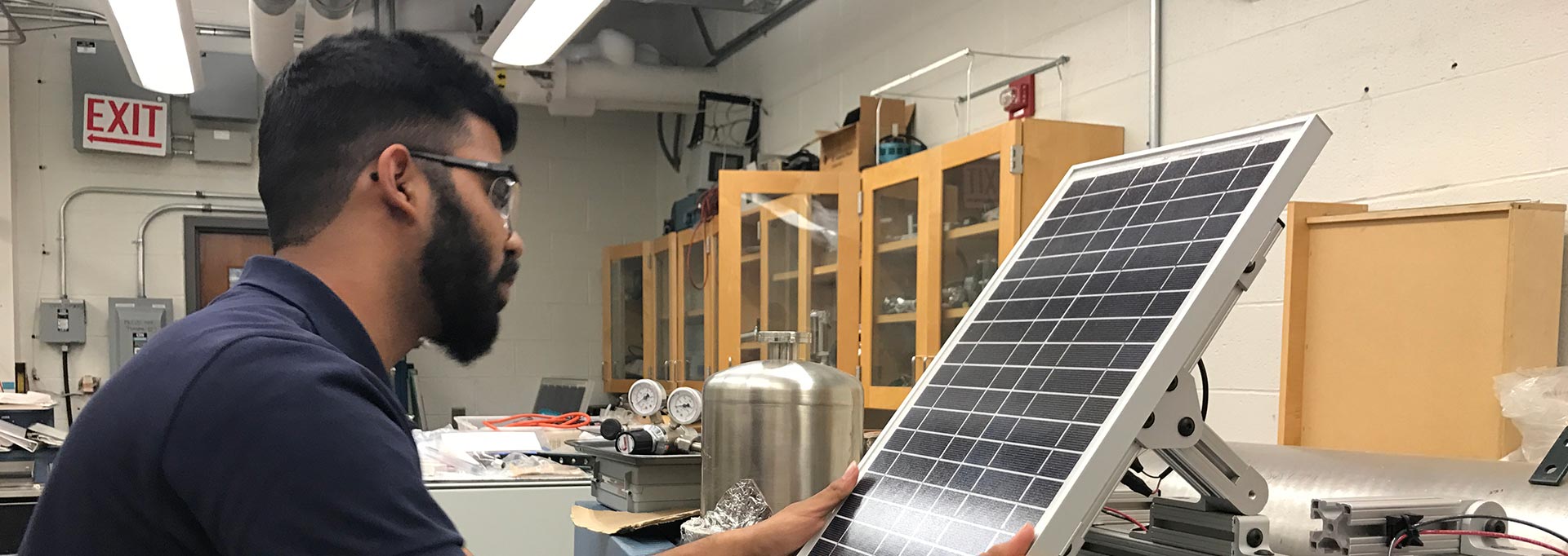 Man working on a solar panel in a lab